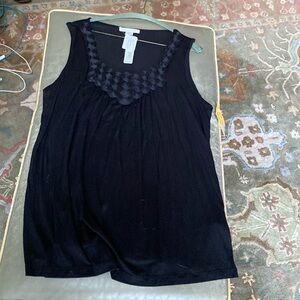 August sill black shirt with black beaded circles of flowers.